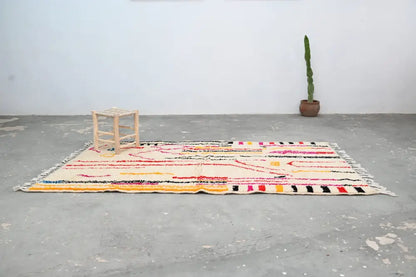 DecorBites™ handmade traditional azilal rug with cream base and vibrant pink black yellow red and orange geometric patterns