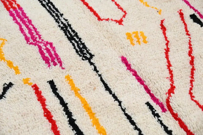 Cream-colored decorbites™ handmade traditional azilal rug with bold pink red black and yellow geometric patterns 253x144 cm