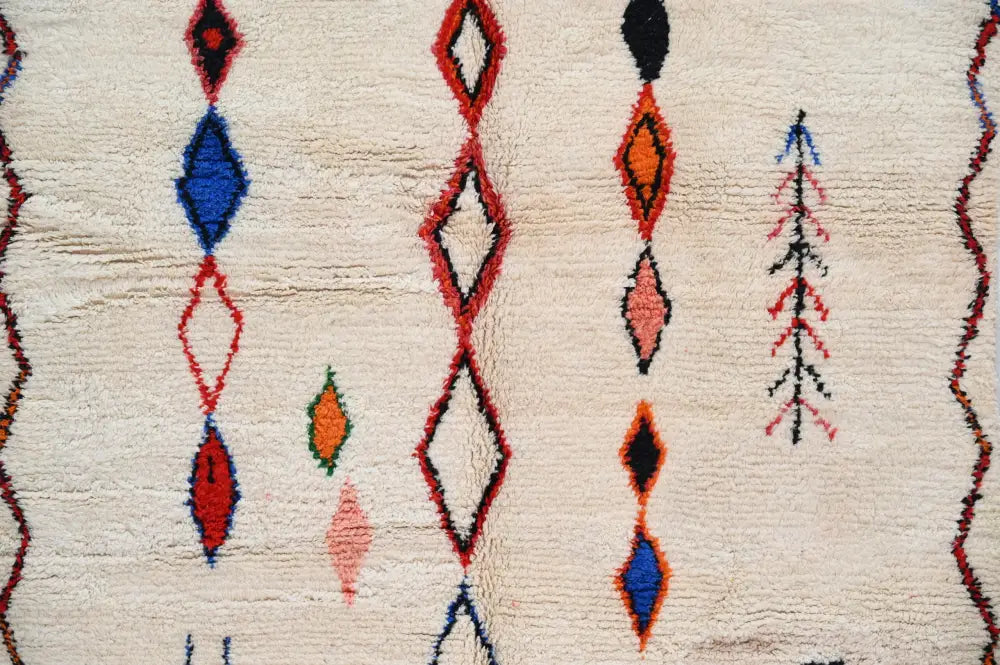 Beige handmade moroccan azilal rug with geometric red blue orange and black patterns 285x220 cm by DecorBites