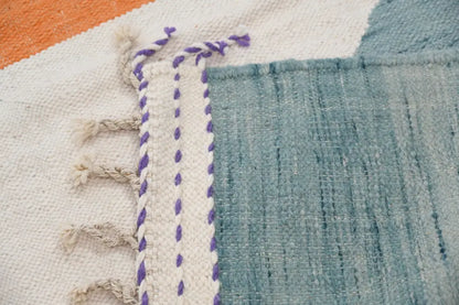 Decorbites™ handmade moroccan azilal rug in natural wool featuring white base with teal blue and purple braided border