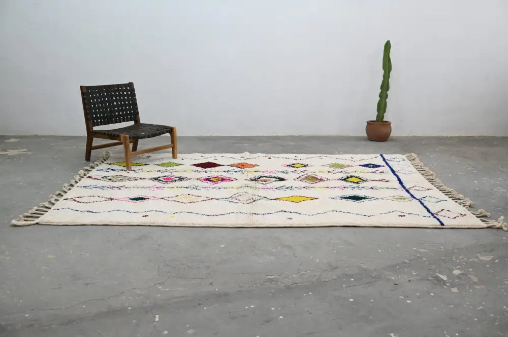 Cream-colored DecorBites™ handmade moroccan azilal rug with colorful geometric patterns and fringed edges 293x206cm