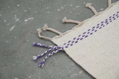 Cream-colored decorbites™ handmade moroccan azilal rug with purple stitched dots and braided tassels 300x203 cm