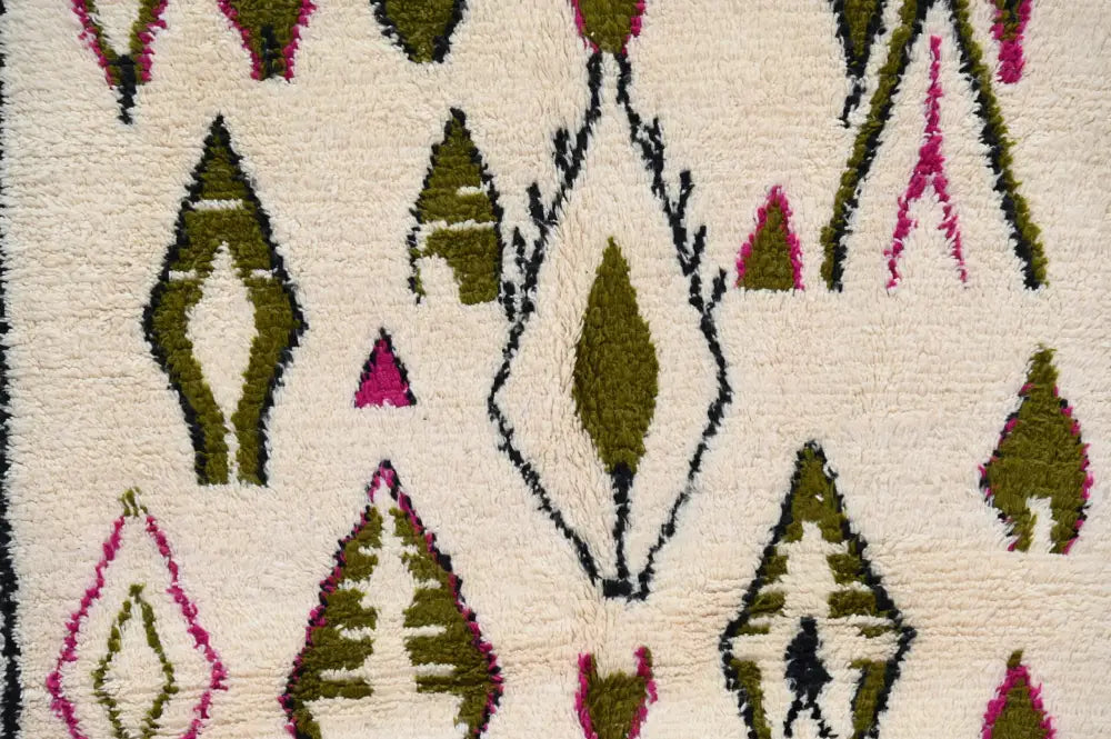 Cream-colored handmade moroccan azilal rug with geometric olive green and magenta diamond motifs outlined in black