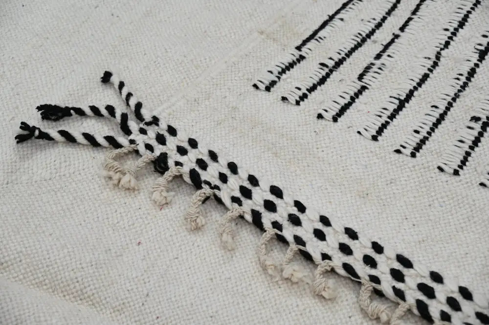 Handmade Moroccan Azilal rug with black and white woven stripes and dots featuring fringed tassel edges 308x200 cm