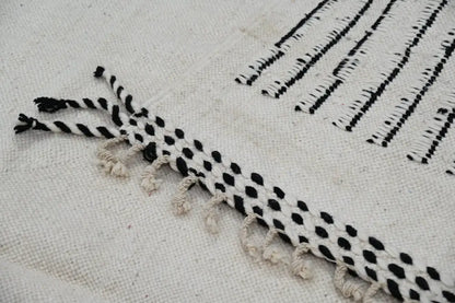 Handmade Moroccan Azilal rug with black and white woven stripes and dots featuring fringed tassel edges 308x200 cm