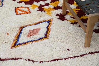 Cream-colored plush wool handmade moroccan azilal rug with maroon orange and blue geometric diamond pattern 309x207cm