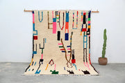 Beige moroccan azilal rug with vibrant pink blue green and black wool geometric patterns handmade 313x194cm decorbites