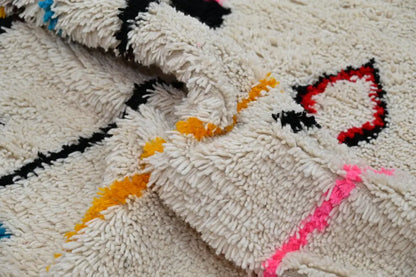 Cream-colored plush wool moroccan azilal rug with bold black red orange and pink geometric patterns 313x194cm