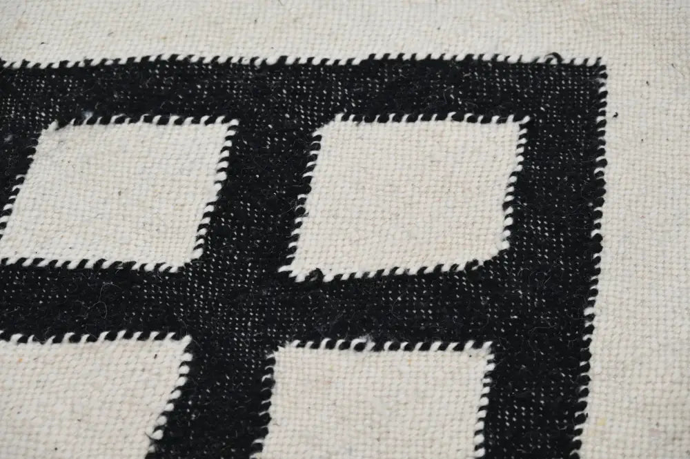 Decorbites™ handmade moroccan azilal rug featuring a black and white geometric grid pattern with textured borders