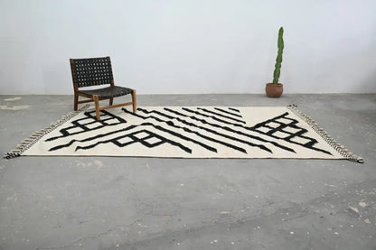 Cream-colored handmade Moroccan azilal rug with bold black geometric patterns and fringed edges 317x200 cm