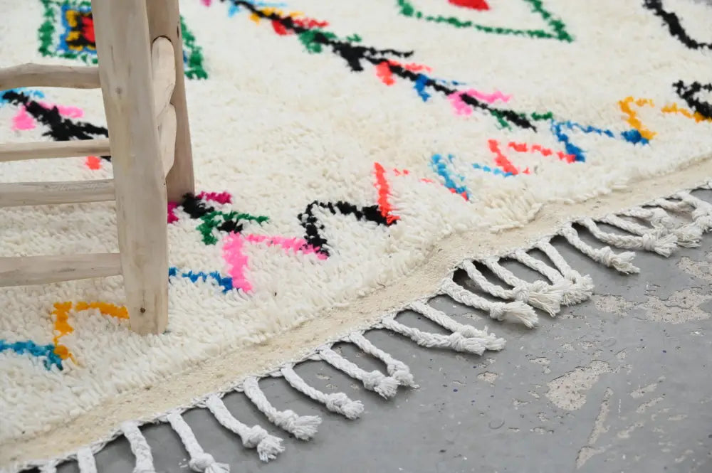 DecorBites™ handmade traditional azilal rug 240x150cm with vibrant cream base and bold geometric patterns in soft fluffy texture
