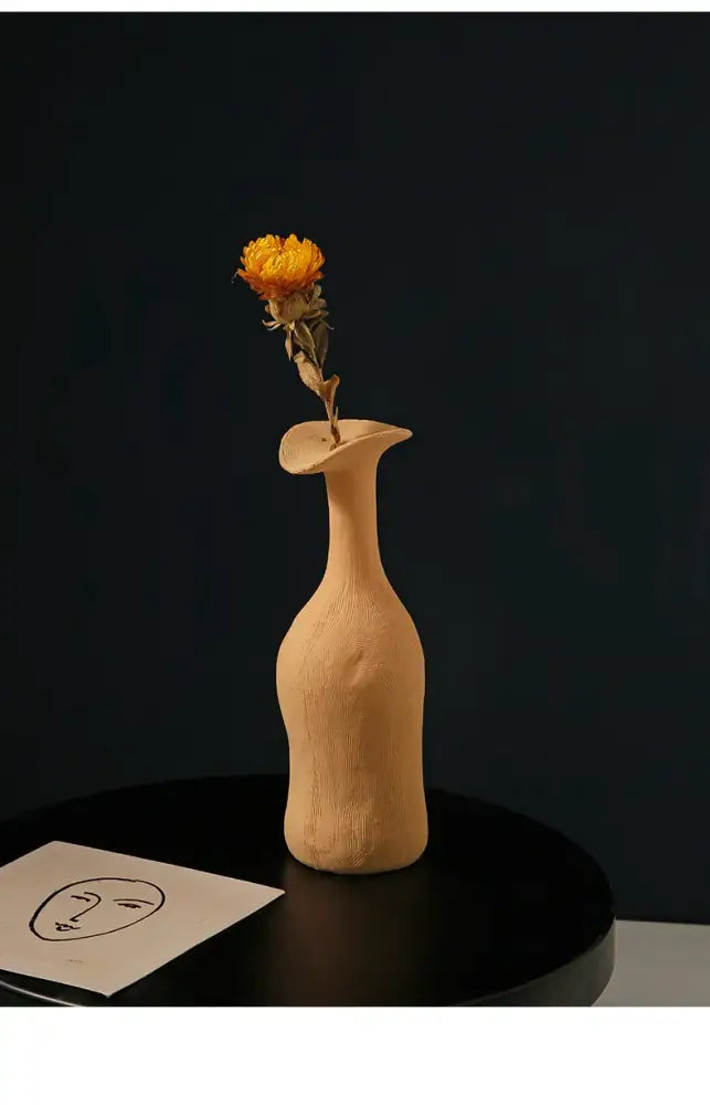 DecorBites™ handmade beige ceramic flower vase with slender neck holding a dried orange flower for luxury home