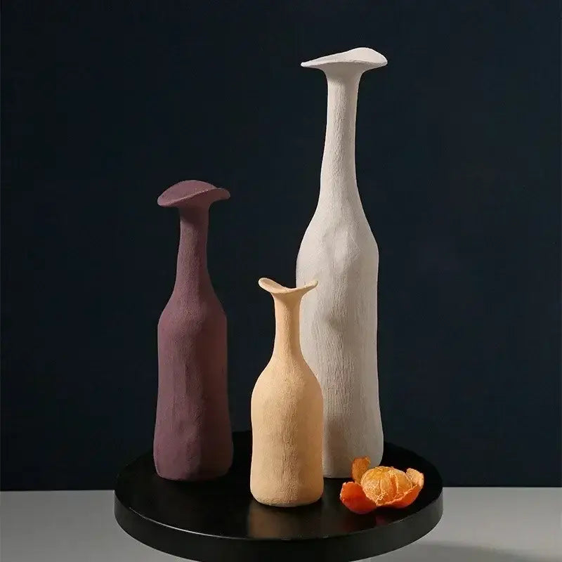 DecorBites™ handmade nordic ceramic flower vases in muted purple beige and white on a black circular base