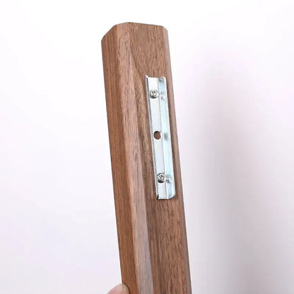 Brown wooden picture frame bracket with silver metal mounting plate on the backside of handmade nordic solid wood wall vase