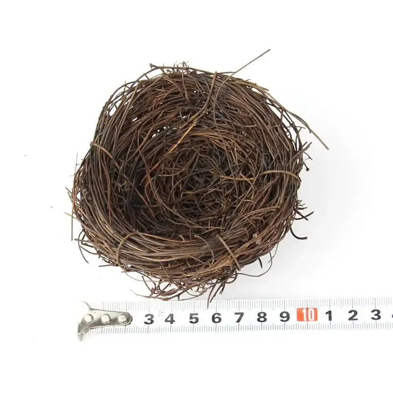 DecorBites™ handmade round rattan bird nest decoration made of brown intertwined twigs and dried plant fibers