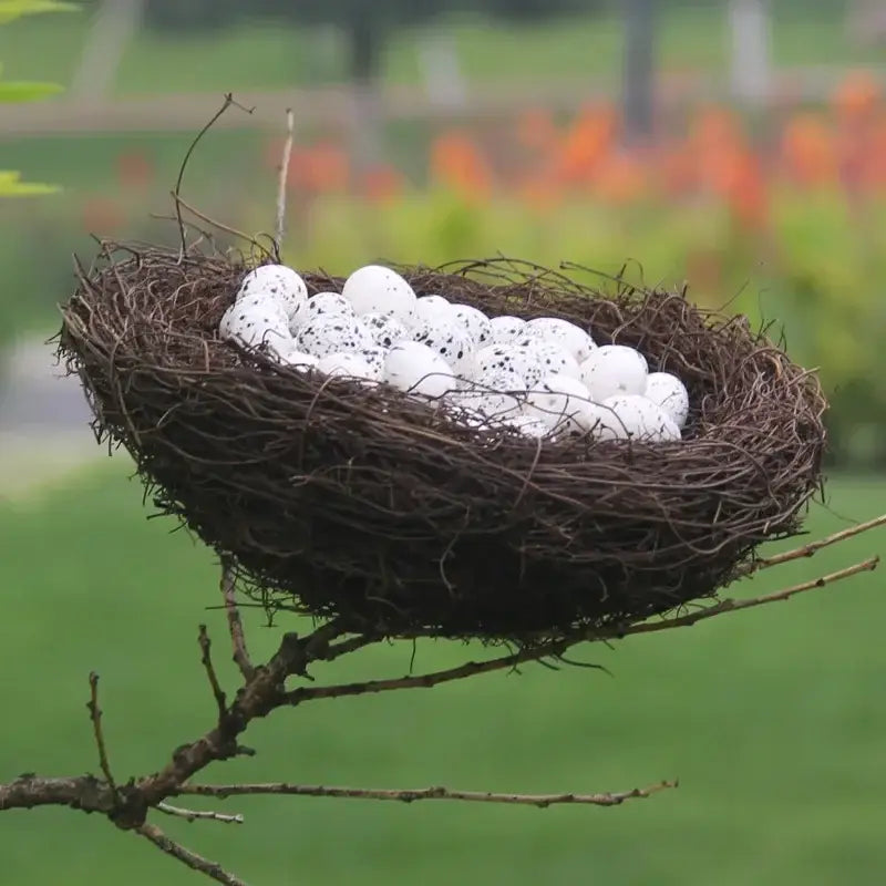 DecorBites™ handmade round rattan bird nest decoration with rustic brown woven design holding white speckled eggs