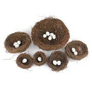 Set of six rustic brown handmade rattan bird nests with white speckled eggs for decoration by DecorBites