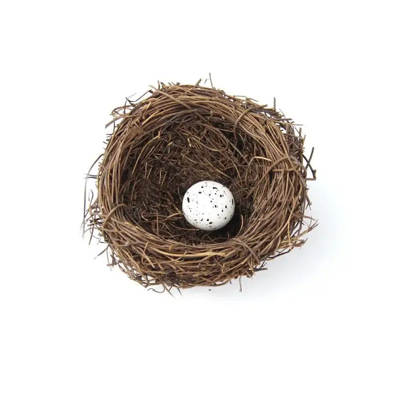 DecorBites™ handmade round rattan bird nest decoration with a white speckled egg nestled inside a woven brown bird nest