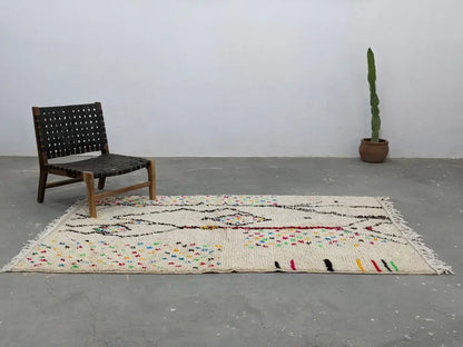 Beige handwoven moroccan azilal rug with colorful geometric patterns and fringed edges 234x147 cm by decorbites