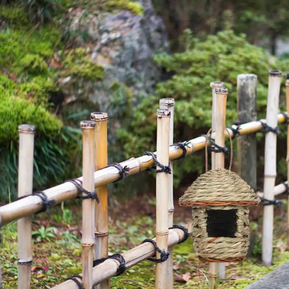 DecorBites™ handwoven straw bird nest with thatched roof and dark rectangular entrance for outdoor gardens