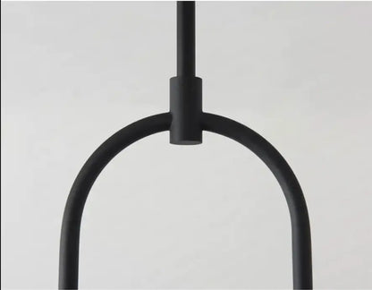 Black matte metal pendant hanging light with minimalist u-shaped design offering versatile lighting options by decorbites