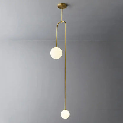 Modern brass pendant hanging light with two frosted glass spheres and gold finishes by decorbites versatile lighting options