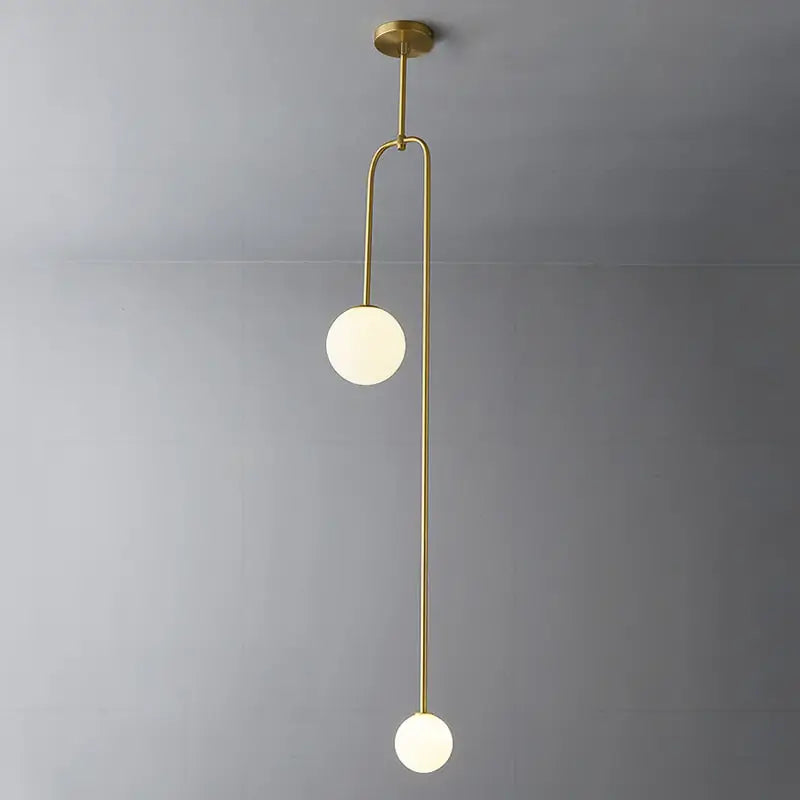 Modern brass pendant hanging light with two frosted glass spheres and gold finishes by decorbites versatile lighting options
