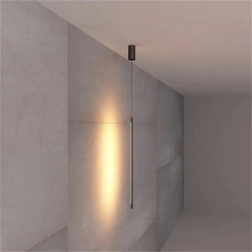 Minimalist black cylindrical hanging pendant light from decorbites with warm focused glow for bedroom lighting