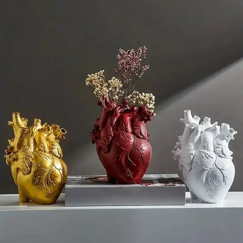 Red anatomically detailed heart shape resin vase by DecorBites holding dried flowers in vibrant red color