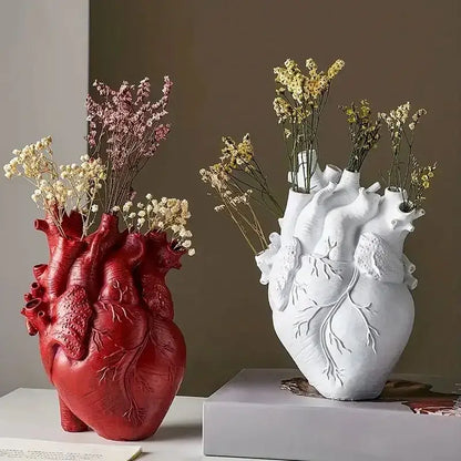 Decorbites™ heart shape resin vase in red and white featuring anatomically detailed design holding dried flowers
