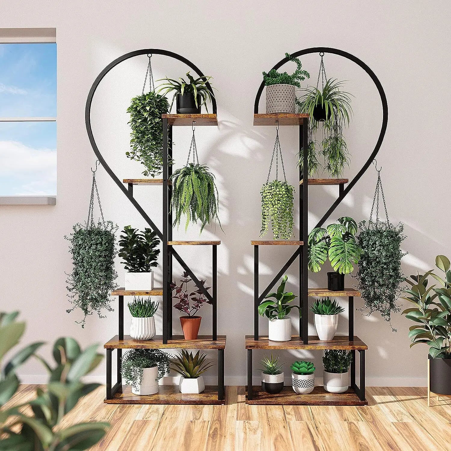 Rustic wooden decorbites™ heart shaped plant stand with black metal frame and hooks holding assorted potted plants