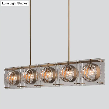 DecorBites™ hexagon glass ball island light fixture with five clear crystal globes in brushed brass finish
