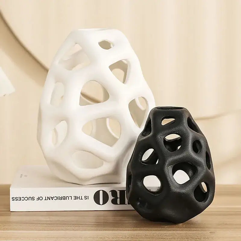 White and black ceramic vase with nordic classical design featuring a hollow out lattice-like pattern by DecorBites
