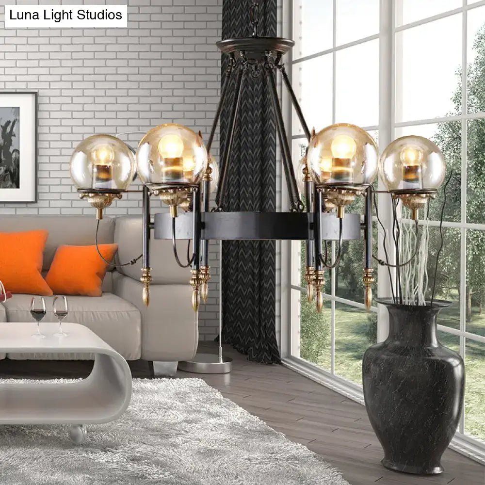 Black wrought iron DecorBites industrial chandelier with four clear glass globe shades and gold-toned accents for living room