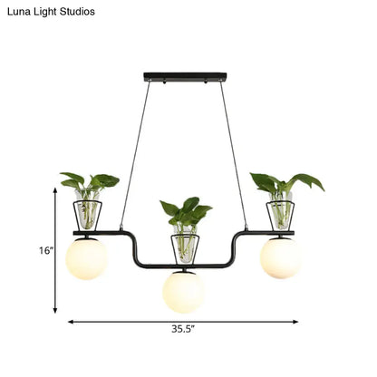DecorBites™ black metal chandelier with three opal glass globes and clear glass pots holding green leafy plants