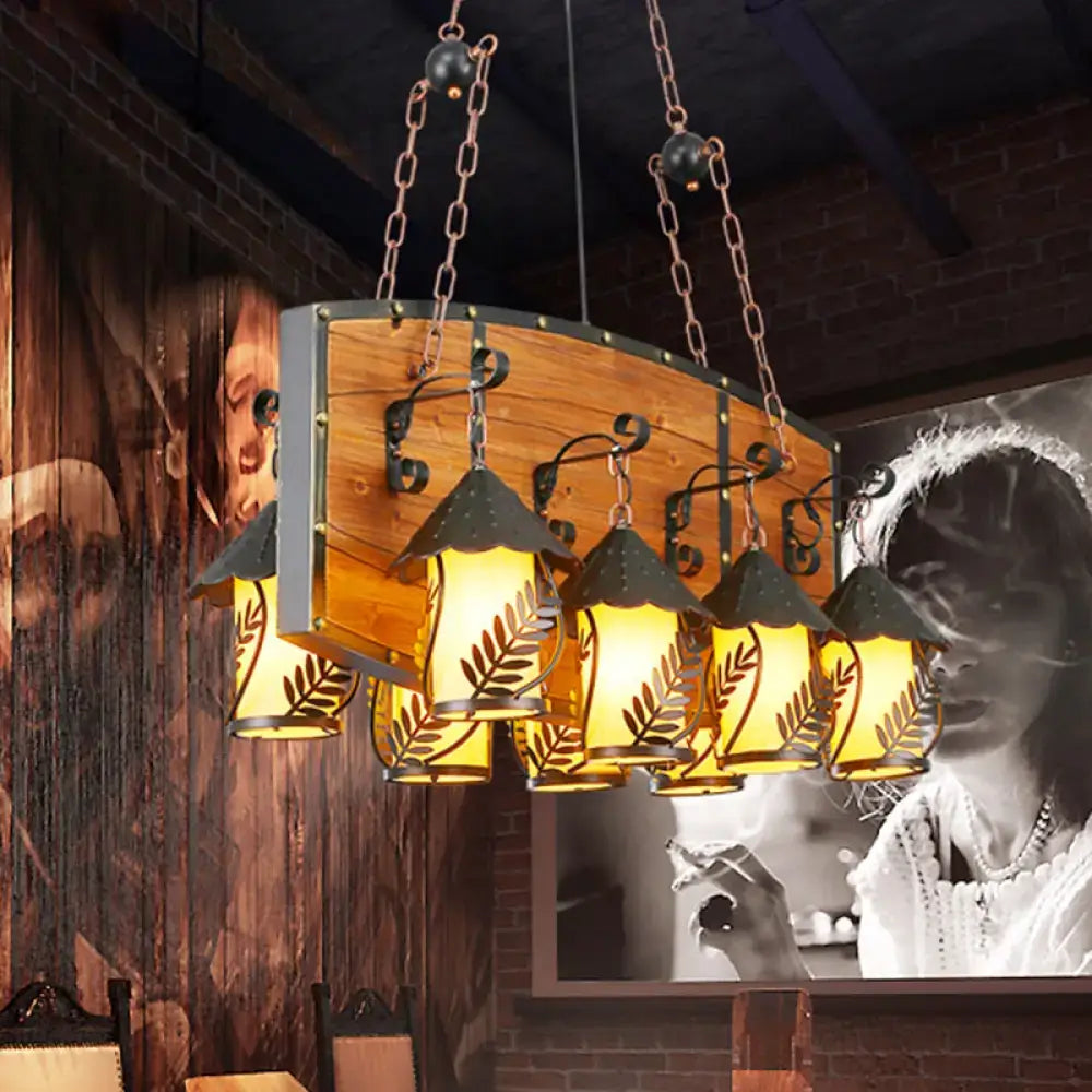 Rustic wooden pendant light with five amber clear glass lanterns, leaf cutouts, and black metal accents for ceiling light