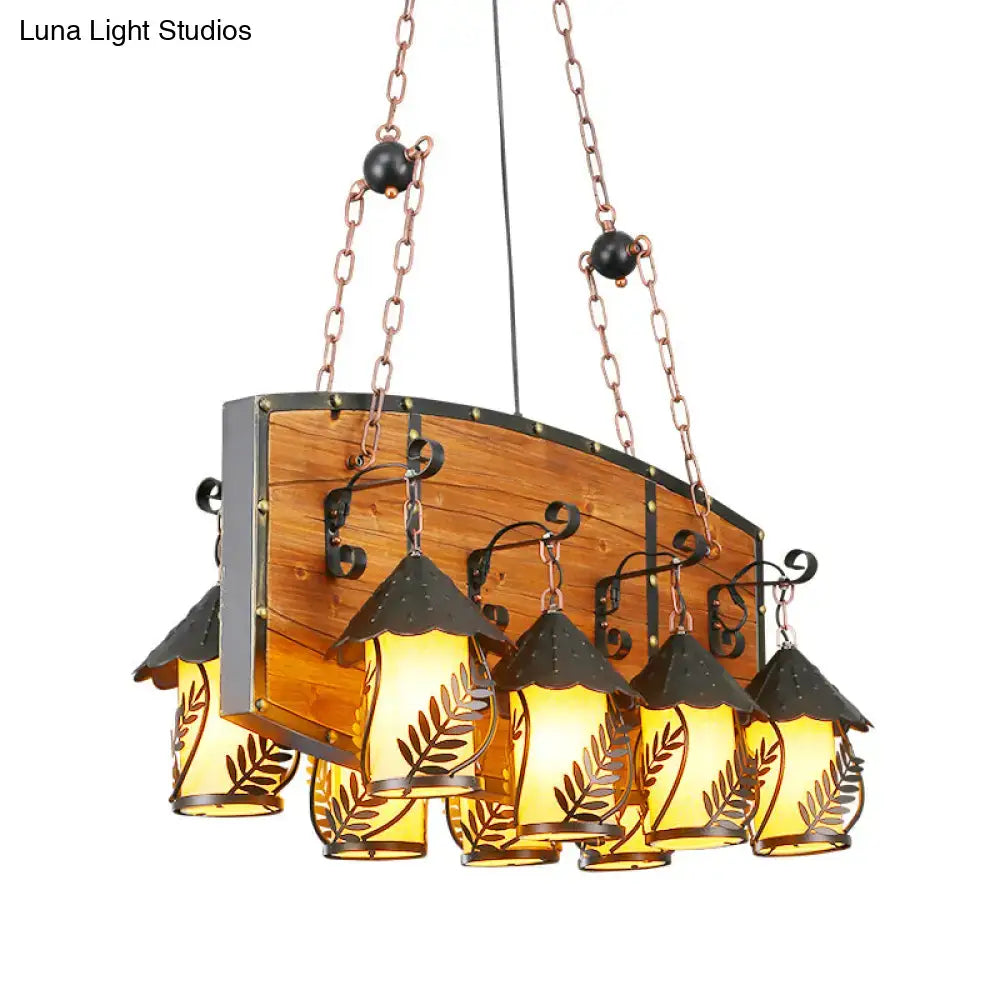 Rustic wooden chandelier with five amber glass lanterns and black metal accents as a pendant light ceiling light with clear glass