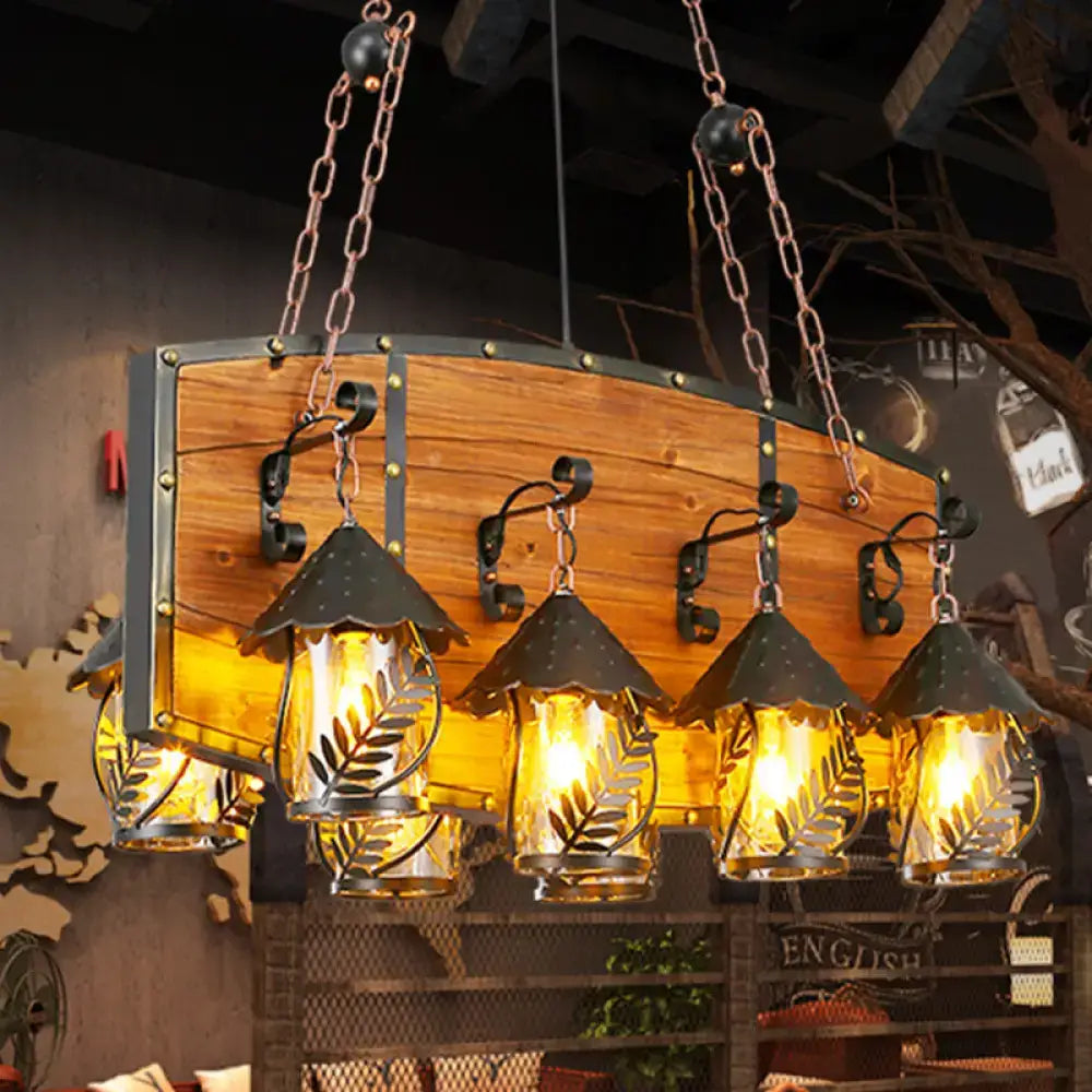 Rustic wooden panel with four decorbites™ industrial black pendant lights featuring clear glass and leaf cutout designs