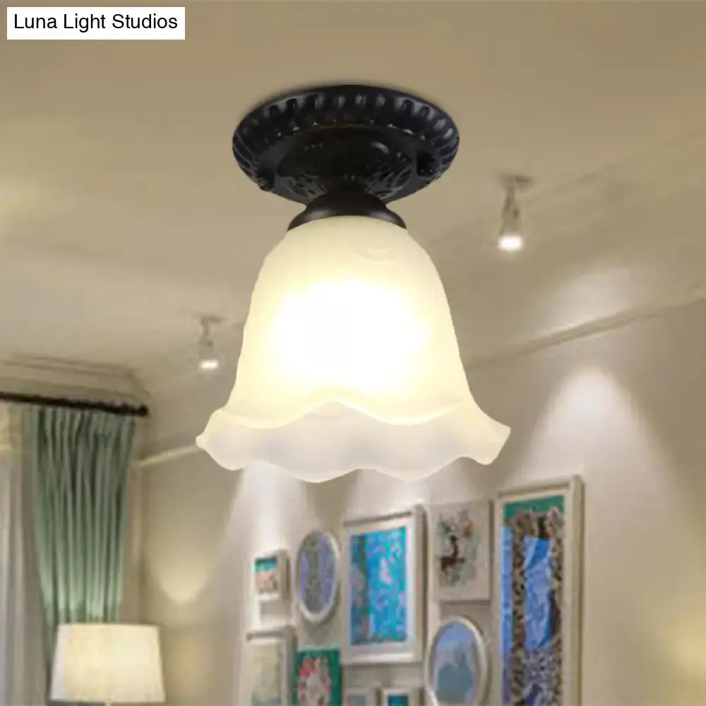 DecorBites semi flush ceiling light with black ornate base and milky glass shade featuring dome flower scalloped edge