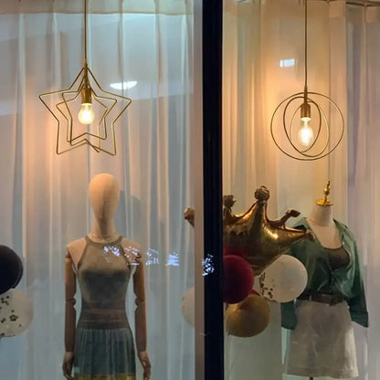 Gold star-shaped pendant light with a visible bulb inside from decorbites industrial chandelier in black circular ring design