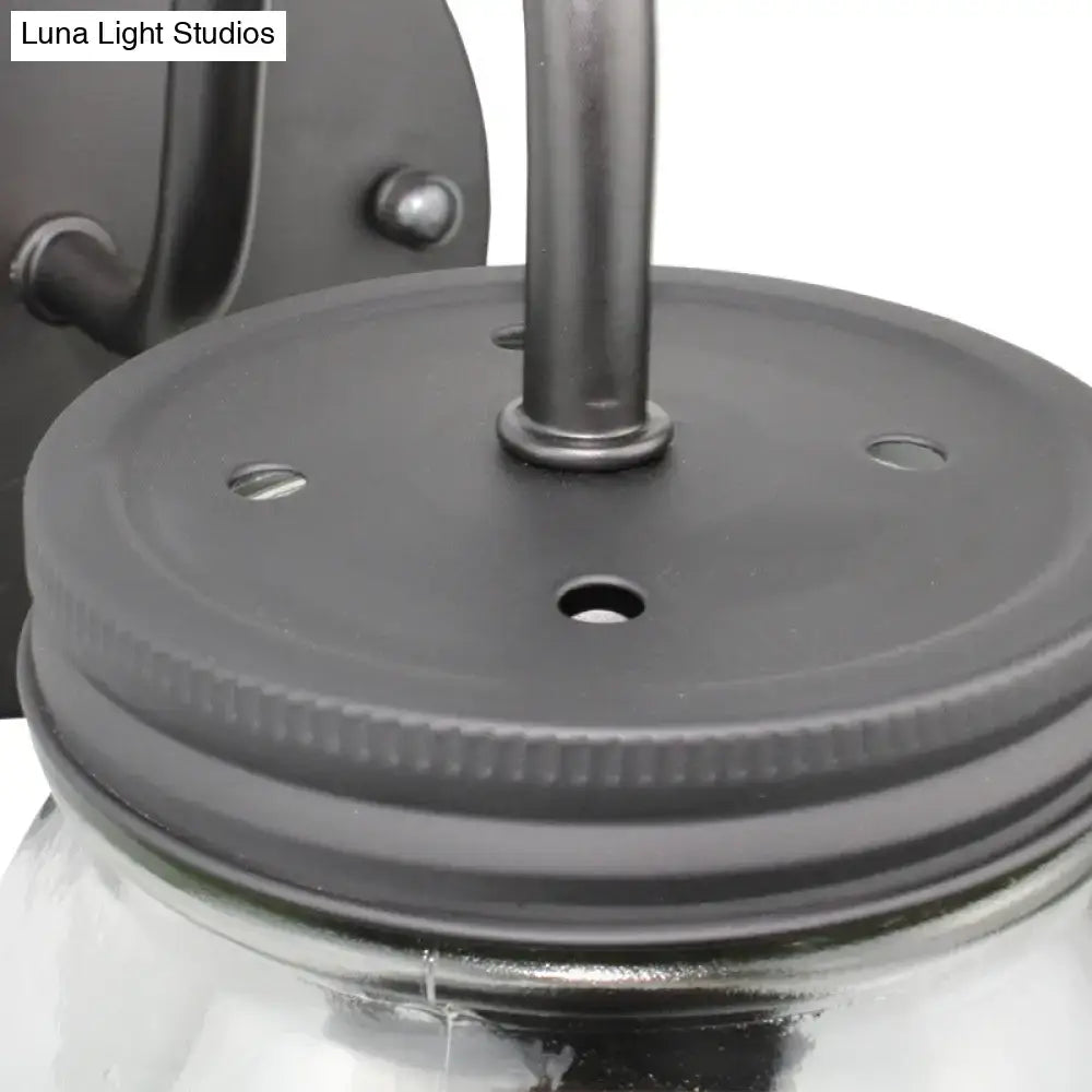 Black metal jar lid with ribbed edge and mounting holes securing clear glass for industrial black jar shade wall lamp