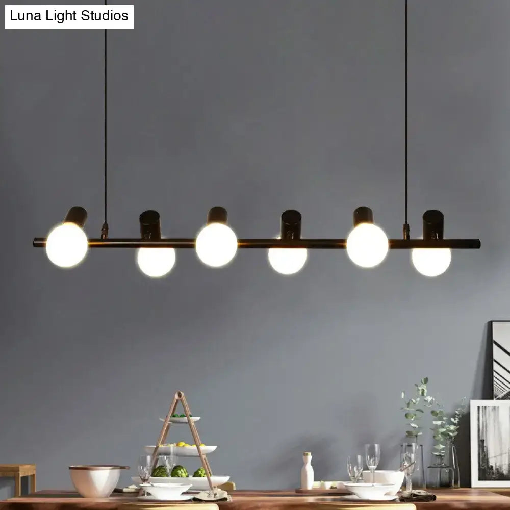 Modern black metal ceiling light with five glowing black naked bulb pendant light bulbs for dining room island