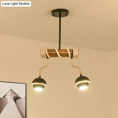 DecorBites™ industrial linear chandelier with wooden beam, twisted rope accents, and two black globe bulbs in black iron