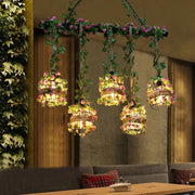 Five head black cage island lighting fixture with woven wire cages and pink green flowers for restaurants and plants