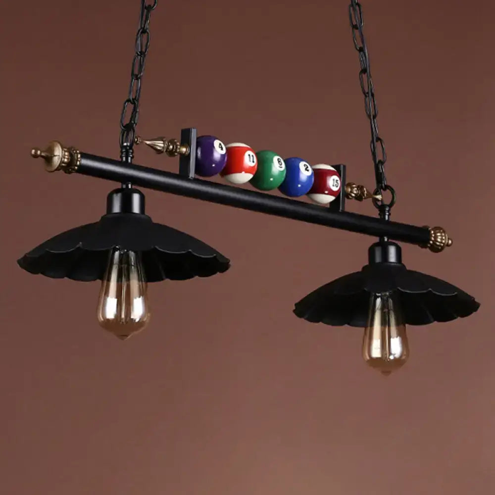 Black industrial metal island pendant light fixture with vintage bulbs and billiard ball decoration for interior spaces