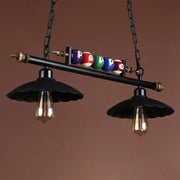 Black industrial metal island pendant light fixture with vintage bulbs and billiard ball decoration for interior spaces