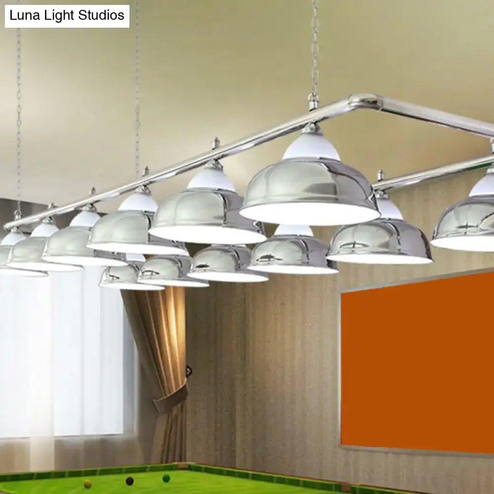 Chrome-finished dome-shaped mirrored bowl pendant lights suspended from a metal bar over a pool table in billiard room