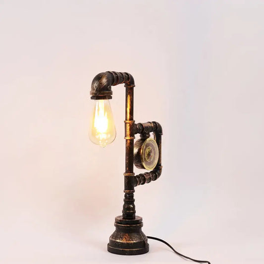 Decorbites industrial metal nightstand lamp with dark aged brass finish and exposed incandescent fluorescent bulb