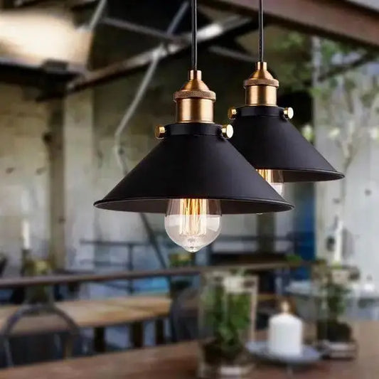 Decorbites™ industrial pendant lighting featuring black metal pendant lights with brass accents and exposed filament bulbs