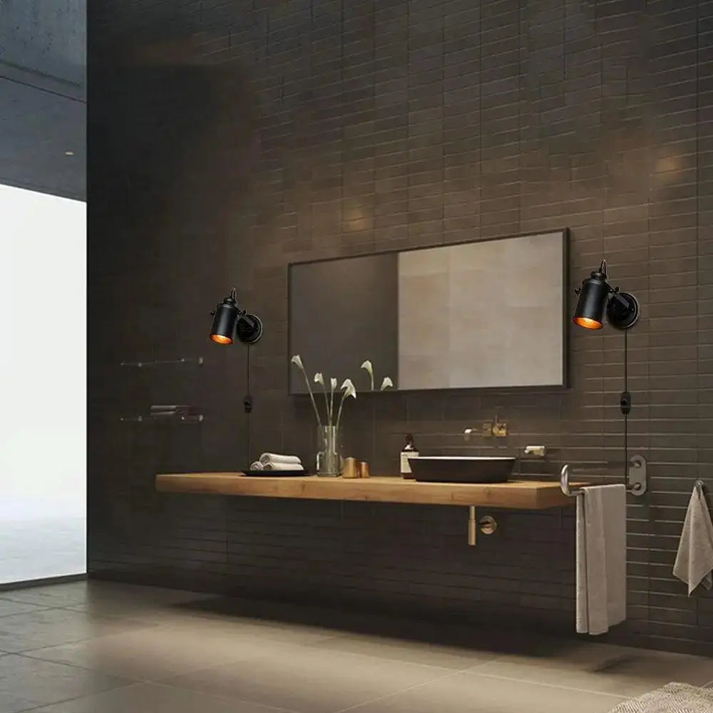 Black industrial-style wall sconce with warm lighting for DecorBites™ aleah wall plug in installation